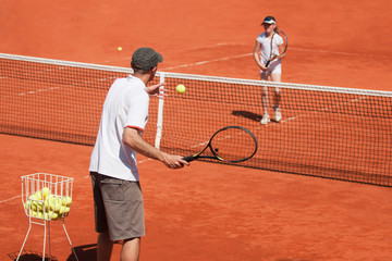 Tennis coach with his student