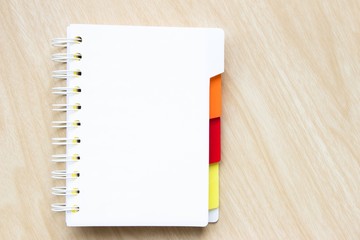 blank notebook on wooden table background.