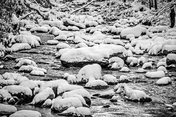 snow and ice covered mountain stream