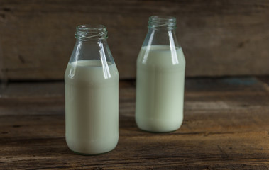Milk in a bottle on a wooden background