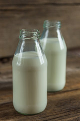 Milk in a bottle on a wooden background