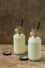 milk in a bottle on a wooden background