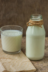 milk in a bottle on a wooden background