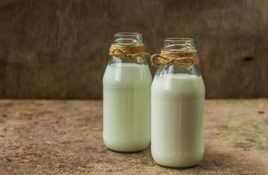milk in a bottle on a wooden background