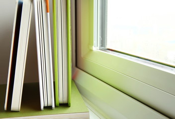 Books put beside the window represent the book background concept related idea.