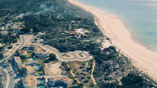 Flying Above Holiday Village on Shore Ocean