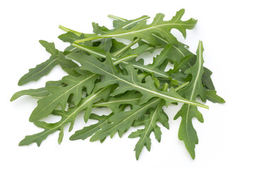 Close up studio shot of green fresh rucola isolated on white background.