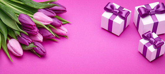 Fototapeta premium Spring tulips and gifts with satin bows