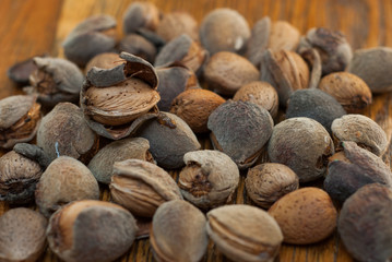 Raw almonds on the wooden background