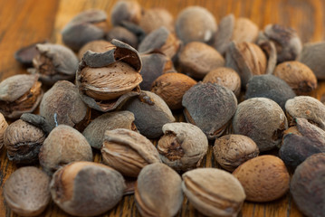 Raw almonds on the wooden background