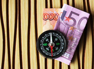Money and compass for travel