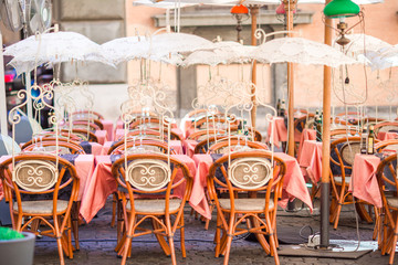 Summer empty open air restaraunt in Pisa in Italy. Closeup wineglasses on the table