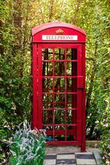 Fototapeta premium Red Phone Booth in the garden