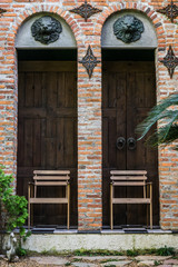 Twin brick arch doorways with wooden chairs