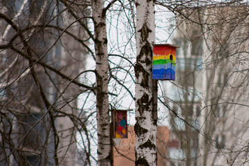 Decorated birdhouses hanging on tree