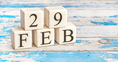 February 29th. Wooden cubes with date of 29 February on old blue wooden background.
