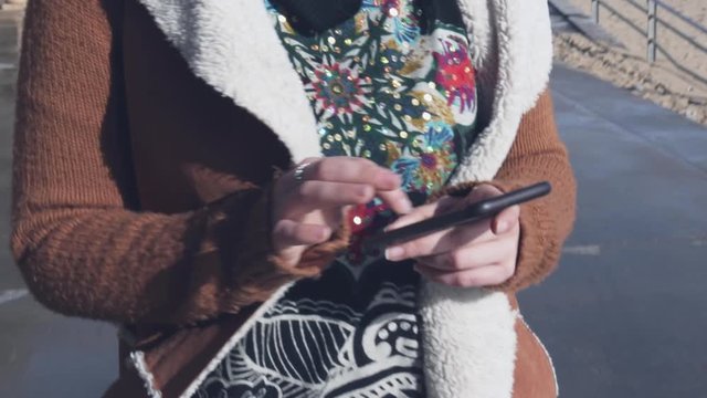 Woman hands using smartphone.