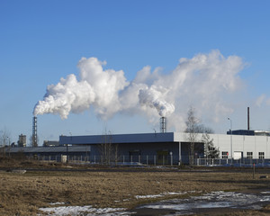 White smoke coming out of the pipe at the factory.