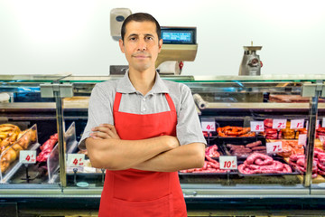butcher standing arms crossed at butchery