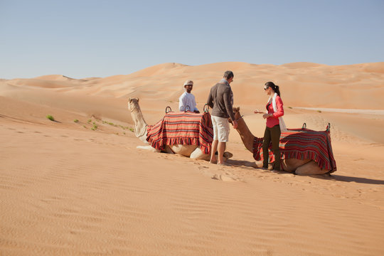 Emirati Man With Couple At Desert.