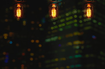 three lamp bulb on city bokeh light at dark night