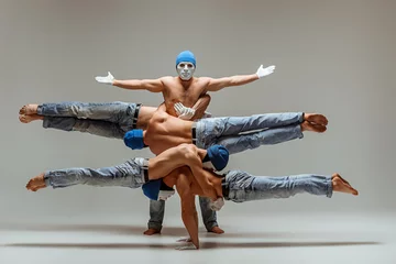 Poster The group of gymnastic acrobatic caucasian men on balance pose © master1305