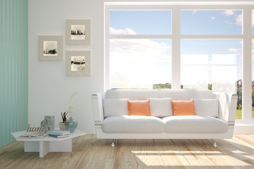 Fototapeta na wymiar White room with sofa and green landscape in window. Scandinavian interior design
