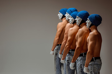 The group of caucasian men in white masks and hats, jeans - obrazy, fototapety, plakaty