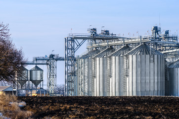The complex silo installations for the storage of grain standing in the plowed © yanik88