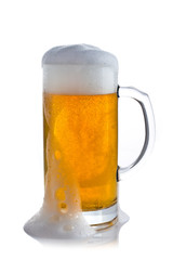 glass of beer with foam on a white background