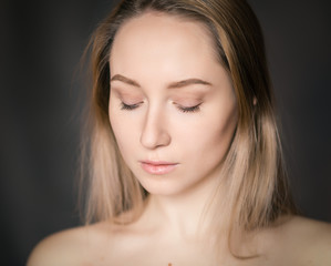 Portrait of a beautiful young woman with blue eyes.