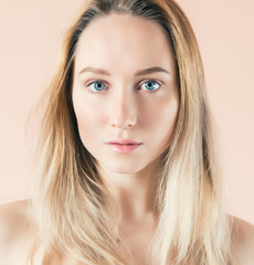 Fototapeta premium Beautiful young woman with blue eyes. Color toned image.