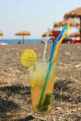 Mohito cocktail on black sand beach