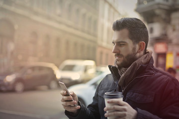 Man likes coffee and phone