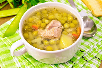 Soup from green peas with meat on napkin