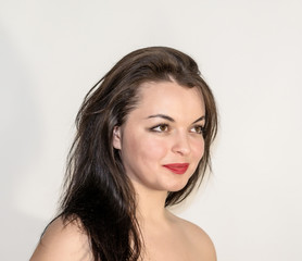 Fototapeta premium Portrait of beautiful girl with black hair on white background. Emotional, smiling