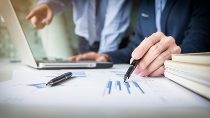Team work process. young business managers crew working with new startup project. labtop on wood table, typing keyboard, texting message, analyze graph plans
