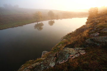 Morning landscape river in rocky coast in morning mist