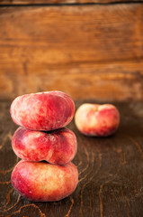 Group of fresh raw peaches on a wooden board. Toned.