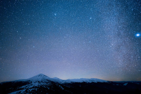 Milky Way above the snowy peaks of the Carpathian Mountains