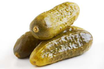 Three preserved pickled cucumbers isolated on white background