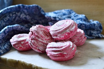 Pink colored marshmallows  on a marble board
