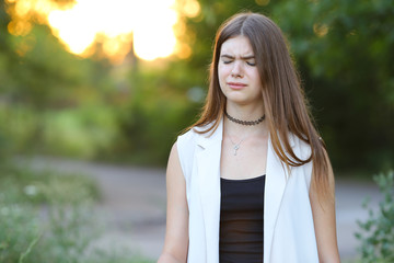 young girl on nature shows emotions