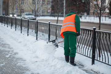 Workers sweep snow from road in winter, Cleaning road from snow storm.