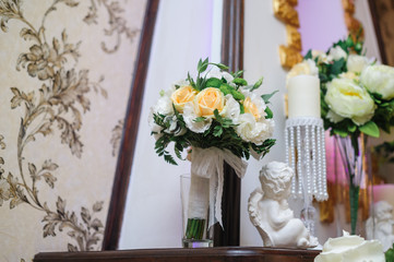 Beautiful bridal bouquet of white and yellow flowers in the interior