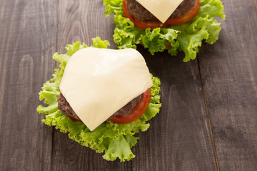 Hamburger with Lettuce and Cheese on wooden table