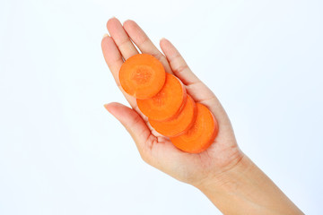 Slice of carrot in woman's hand on white background