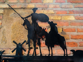 The plate with Don Quixote and Sancho Panza on the wall. Toledo, Spain  - obrazy, fototapety, plakaty