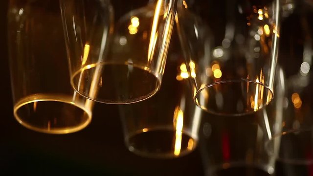 Shot of glasses hanging in a bar with focus transition.
