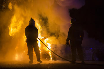 Burning car on the road in night